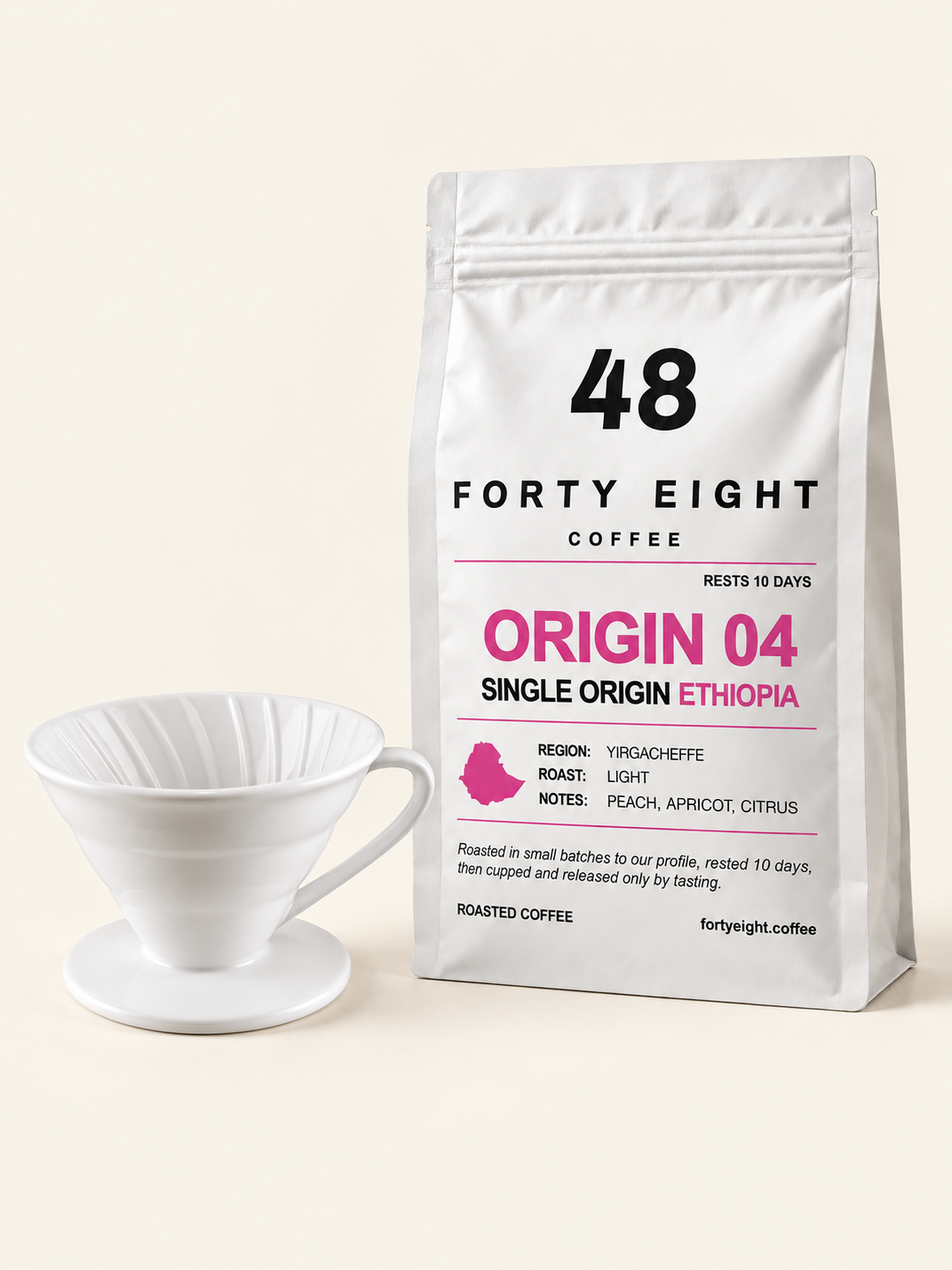 Ceramic pour-over dripper beside a white ORIGIN 04 Ethiopia 250g pouch