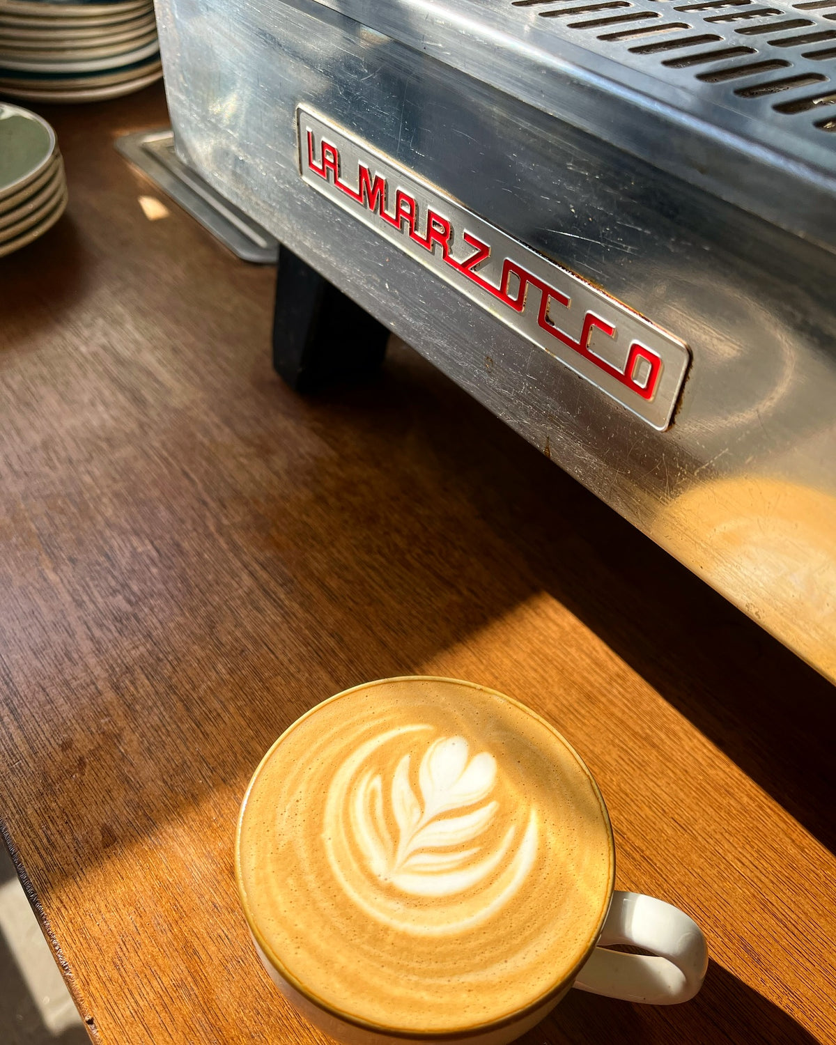 A coffee beside the espresso machine at Forty Eight