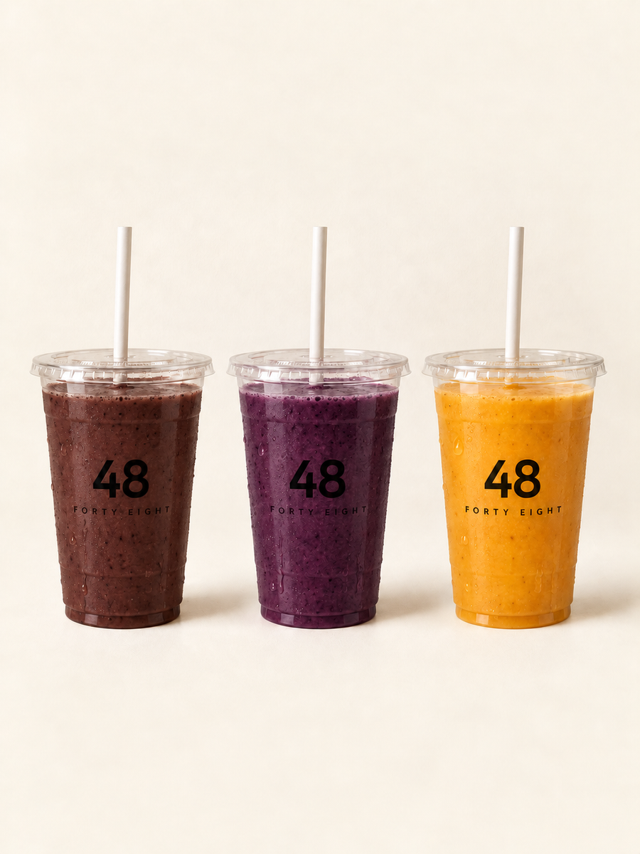 Three Fresh Smoothies in clear plastic cups with flat lids, straws and the Forty Eight logo